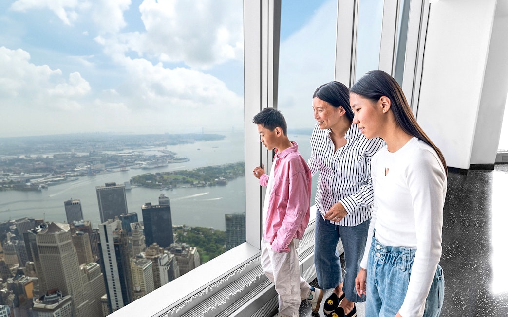 Visitors enjoying New York skyline view from One World Observatory.
