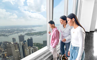 Visitors enjoying New York skyline view from One World Observatory.