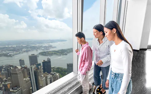 Visitors enjoying New York skyline view from One World Observatory.