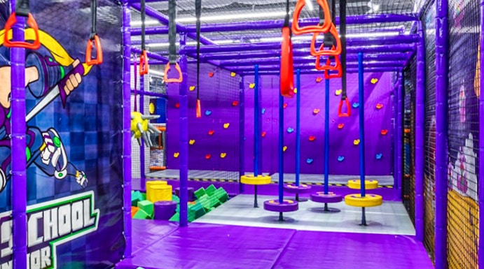Indoor playground with climbing structures and foam pit in Singapore.