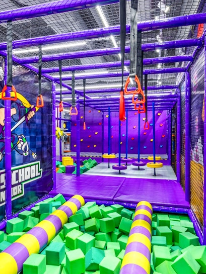 Indoor playground with climbing structures and foam pit in Singapore.