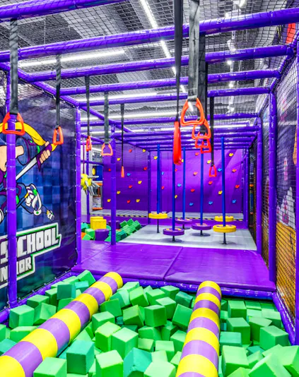 Indoor playground with climbing structures and foam pit in Singapore.