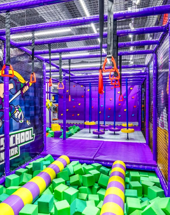 Indoor playground with climbing structures and foam pit in Singapore.