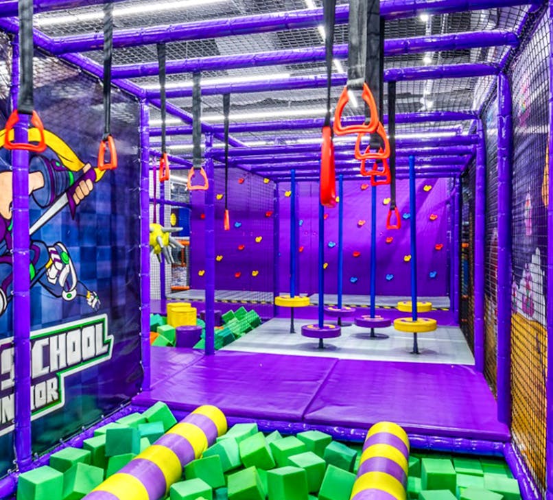 Children playing in a colorful indoor playground in Singapore.