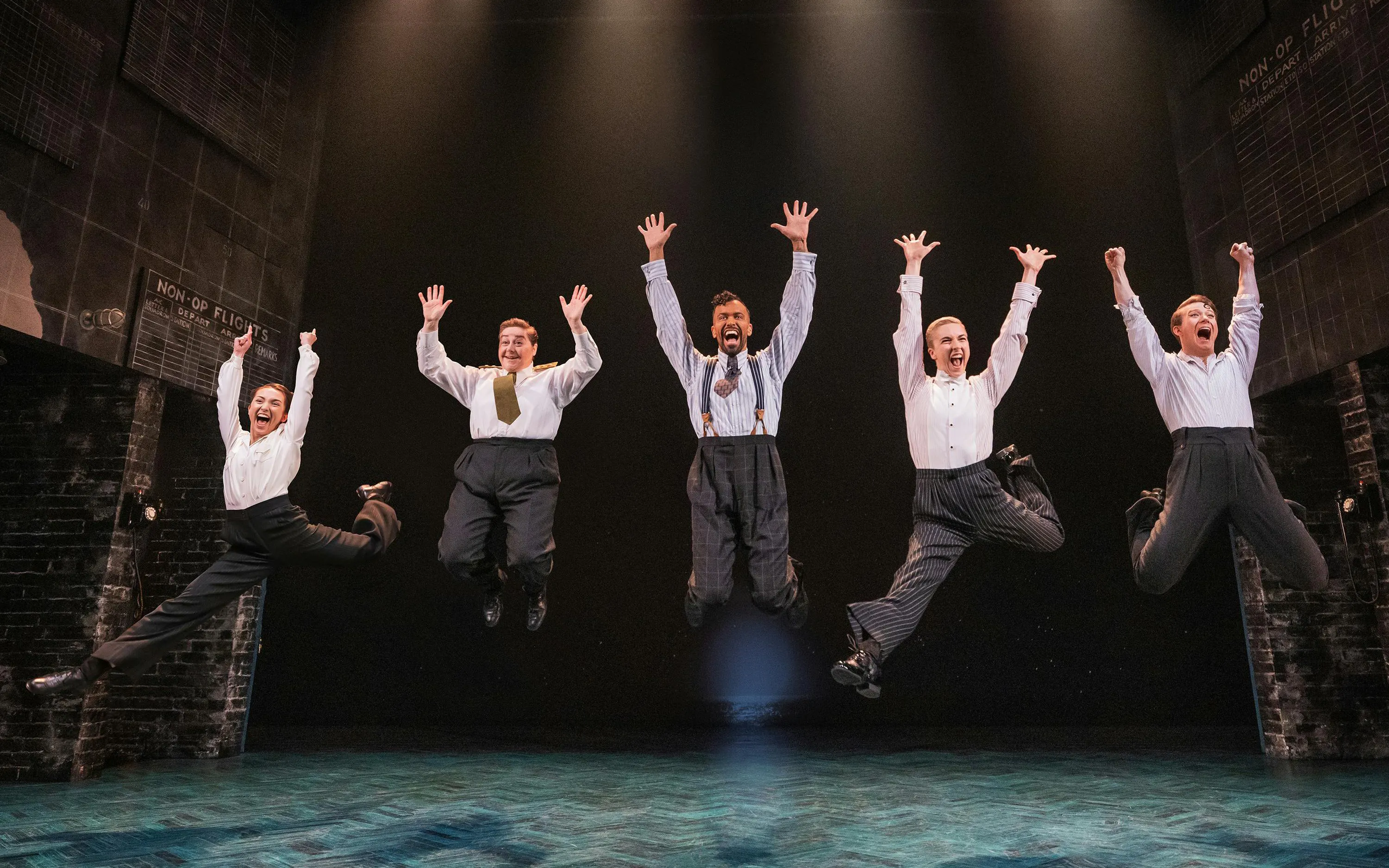 Performers jumping on stage during Operation Mincemeat show, Broadway.