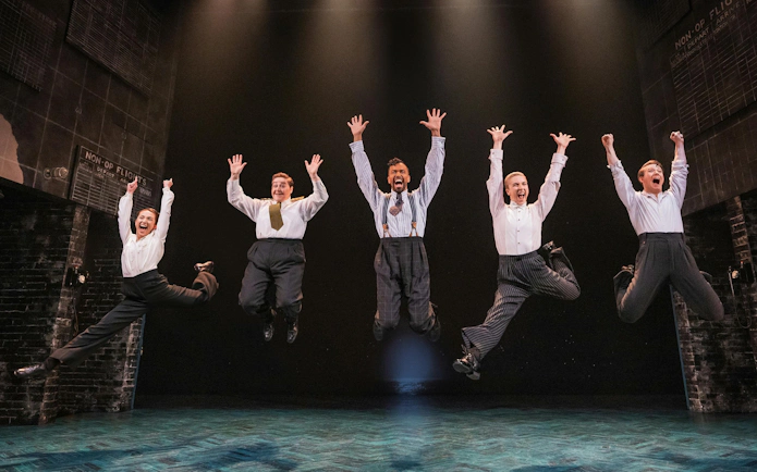 Performers jumping on stage during Operation Mincemeat show, Broadway.