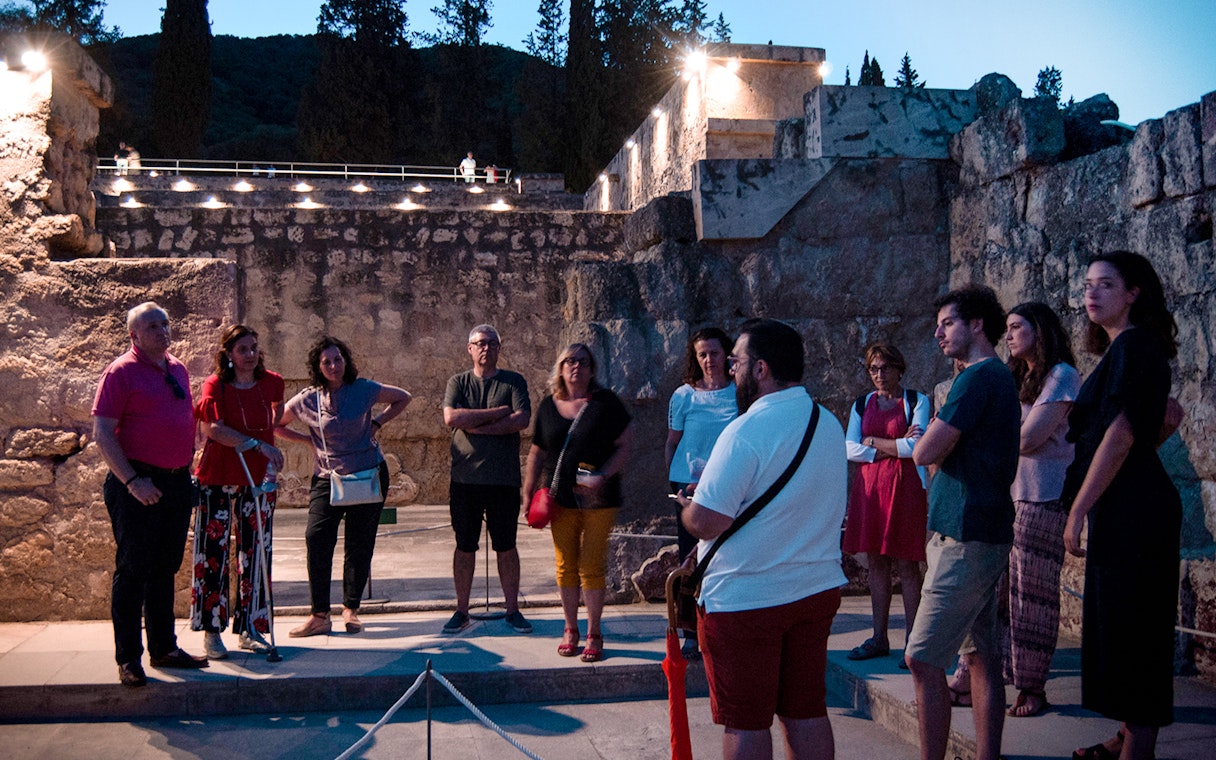 Group of tourists on a guided night tour at Medina Azahara, Córdoba.