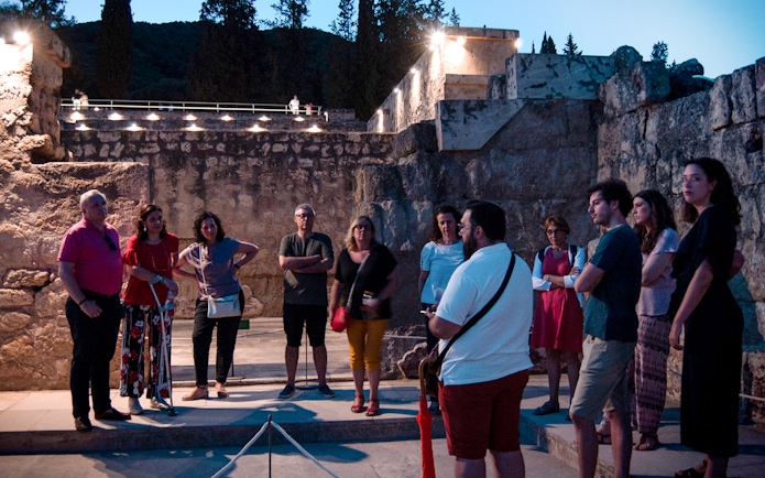 Group of tourists on a guided night tour at Medina Azahara, Córdoba.