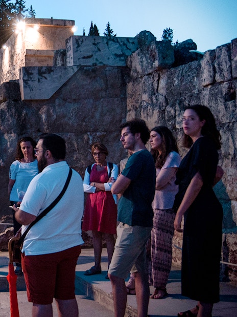 Group of tourists on a guided night tour at Medina Azahara, Córdoba.