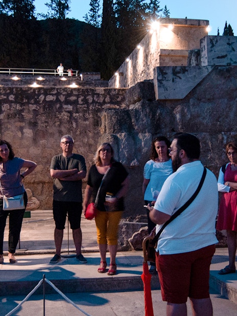 Group of tourists on a guided night tour at Medina Azahara, Córdoba.