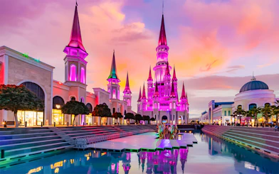 The Land of Legends theme park illuminated at sunset with vibrant colors.