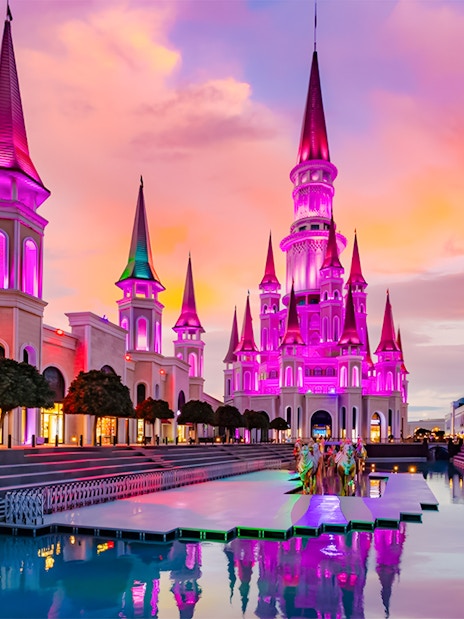 The Land of Legends theme park illuminated at sunset with vibrant colors.