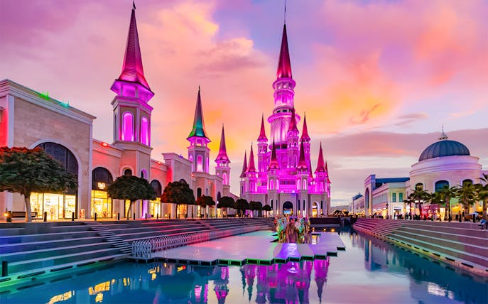The Land of Legends theme park illuminated at sunset with vibrant colors.