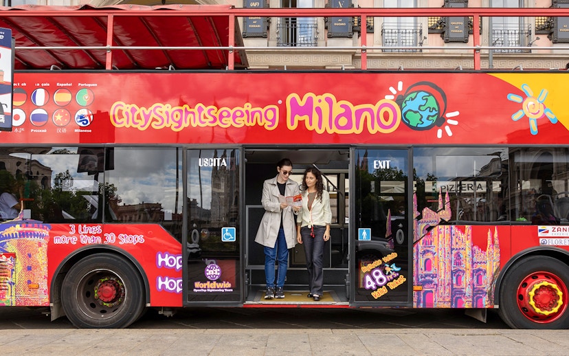 Passengers exiting City Sightseeing hop-on hop-off bus in Milan.