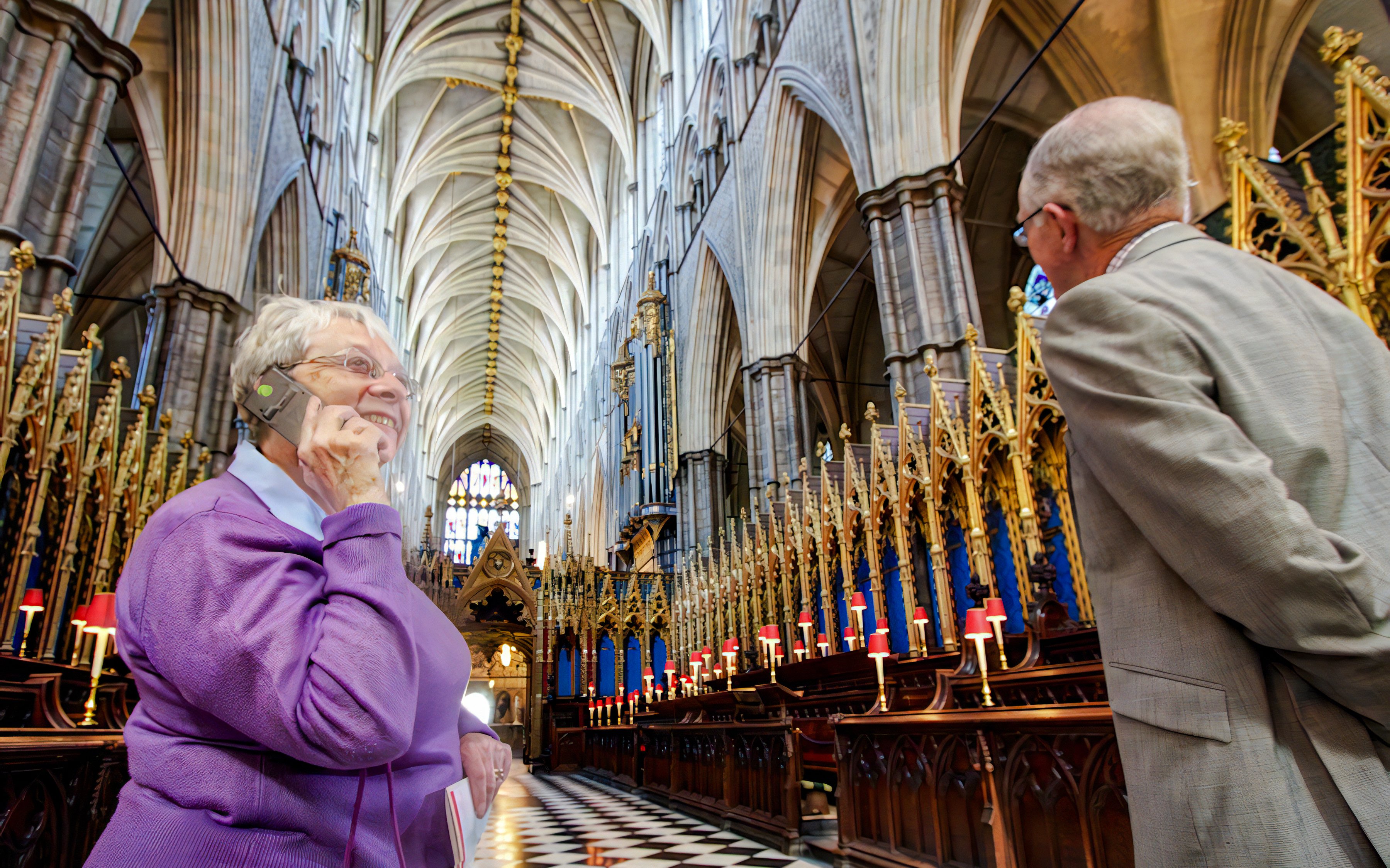 Visitors inside Westminster Abbey during a guided tour, admiring the ornate architecture.