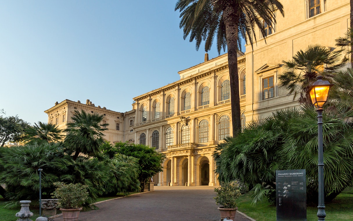 Palazzo Barberini facade with garden and lamp post in Rome.