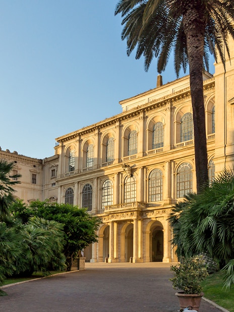 Palazzo Barberini facade with garden and lamp post in Rome.