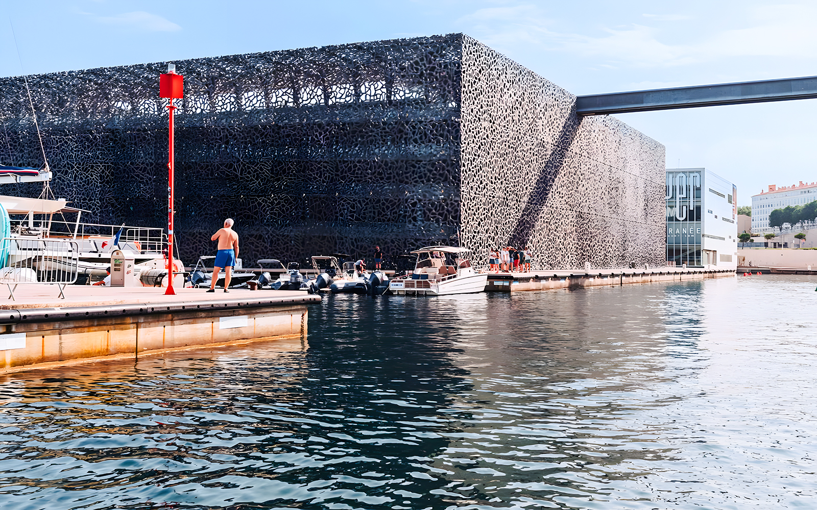 Boats docked near Mucem museum in Marseille during a boat tour experience.