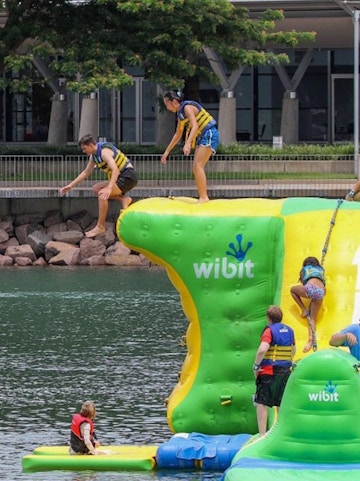 Visitors enjoying inflatable obstacle course at Darwin Aqua Park.
