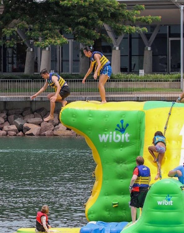 Visitors enjoying inflatable obstacle course at Darwin Aqua Park.