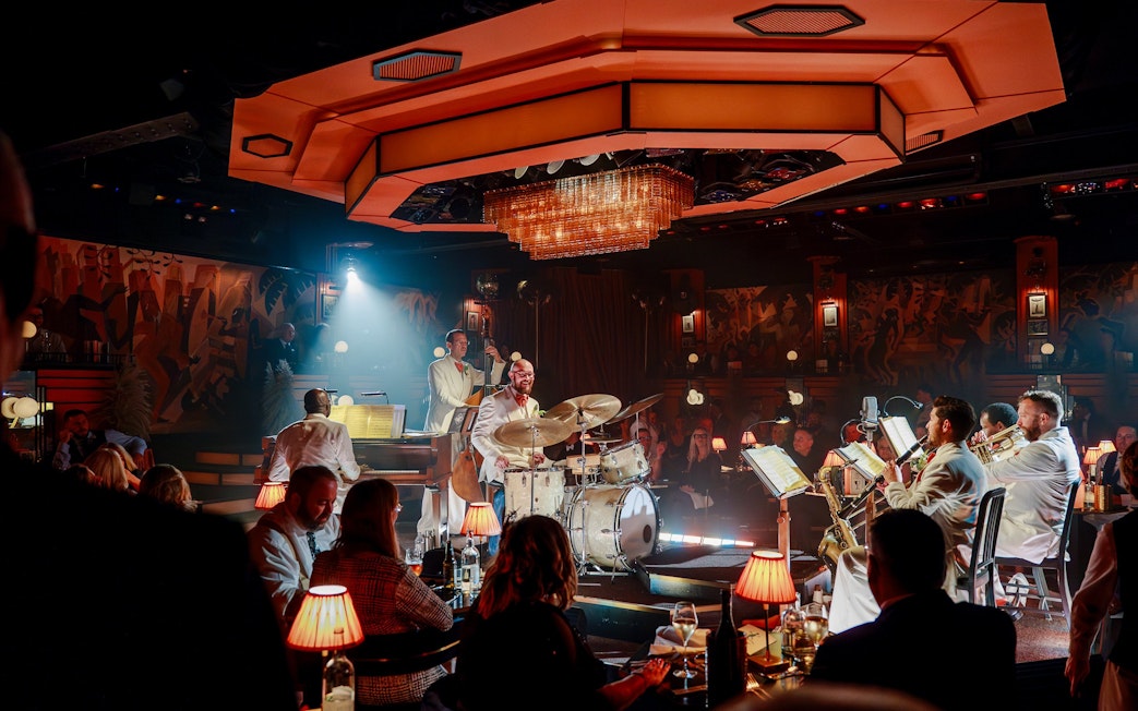 Live jazz band performing at a dimly lit venue on 58th Street with an audience enjoying the show.