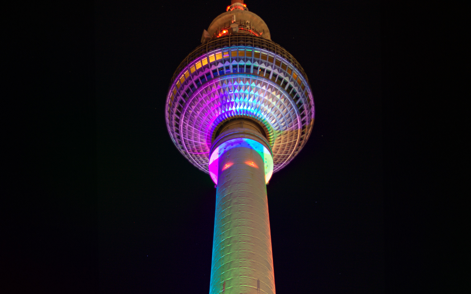 Beleuchteter Berliner Fernsehturm bei Nacht am Alexanderplatz