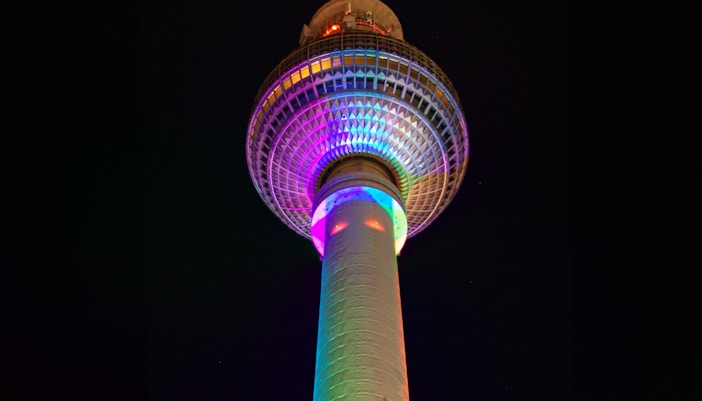 Beleuchteter Berliner Fernsehturm bei Nacht am Alexanderplatz