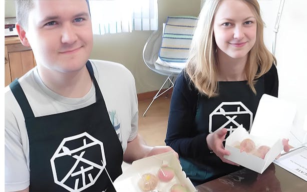 Participants displaying handmade wagashi during a Tokyo wagashi-making class with tea.