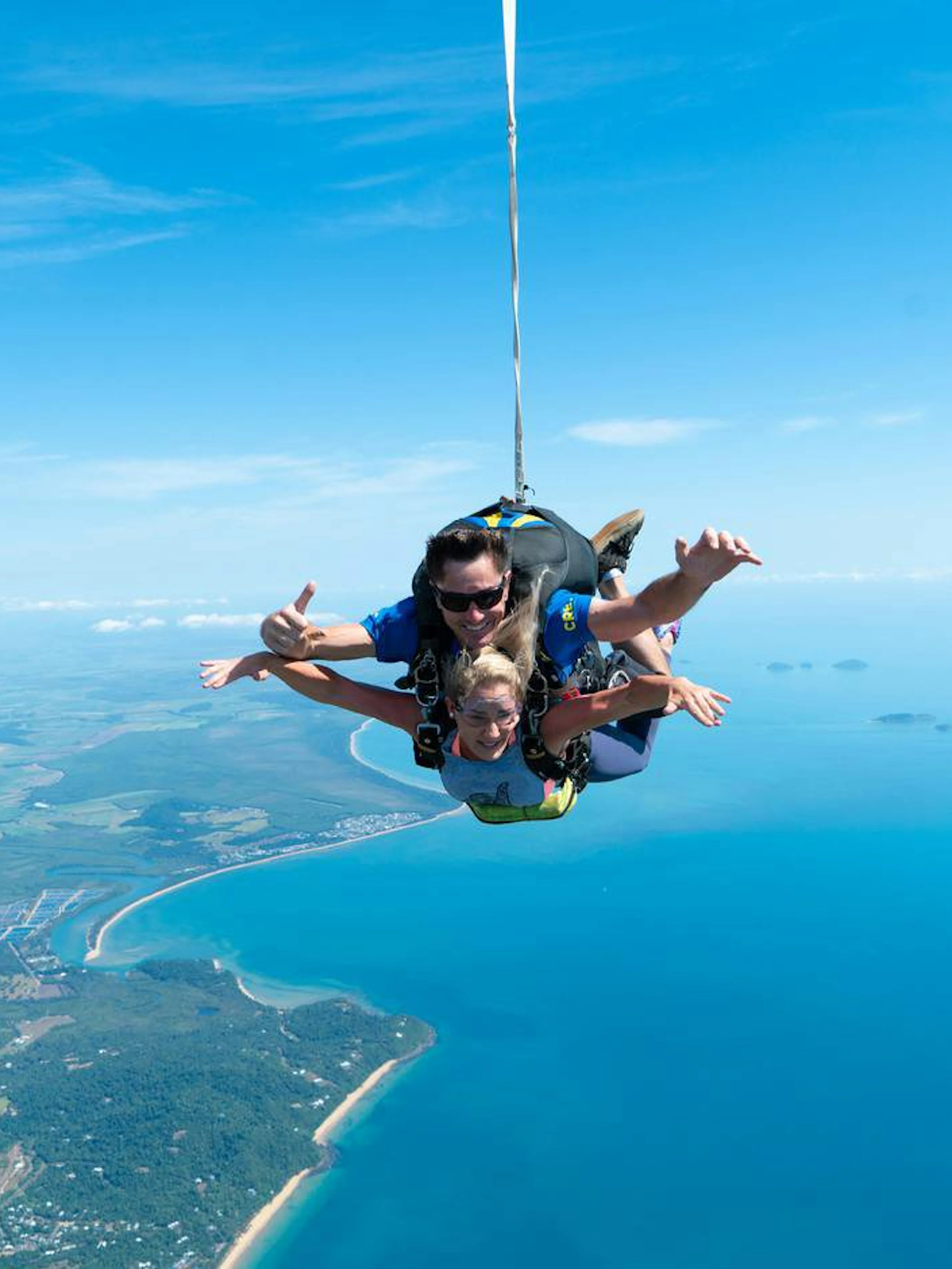 Tandem skydive over Mission Beach with ocean and coastline views.