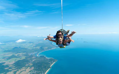 Tandem skydive over Mission Beach with ocean and coastline views.