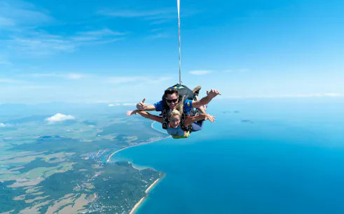 Tandem skydive over Mission Beach with ocean and coastline views.