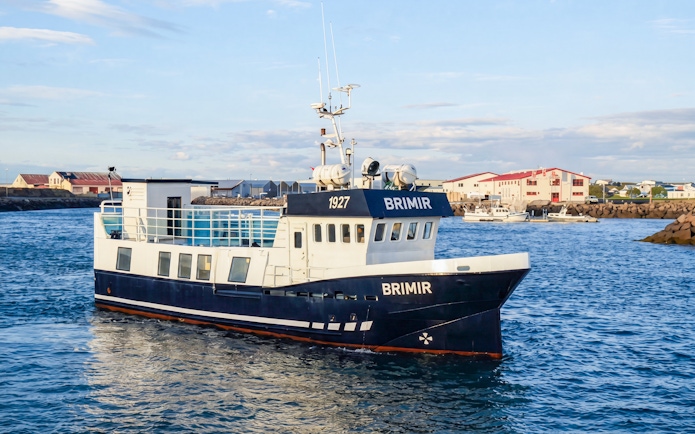 Whale watching boat in Akureyri harbor, Iceland, ready for a cruise-friendly tour.