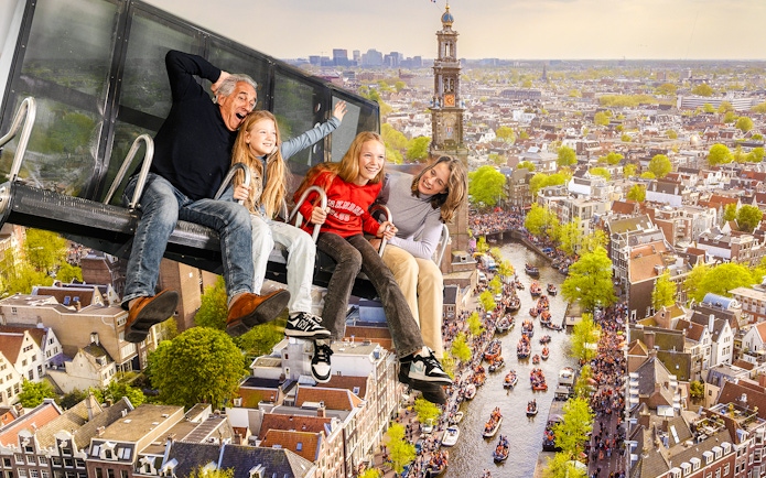 Tourists enjoying 5D ride at This Is Holland with aerial view of Amsterdam canal.