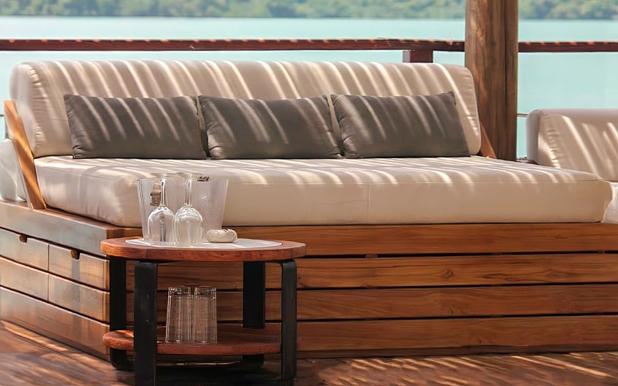 Sunset terrace seating at Yona Beach Club, Phuket, with ocean view.