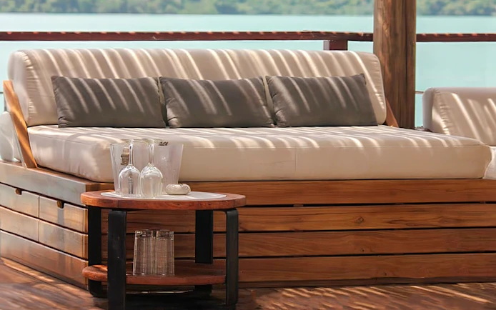 Sunset terrace seating at Yona Beach Club, Phuket, with ocean view.