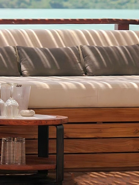 Sunset terrace seating at Yona Beach Club, Phuket, with ocean view.