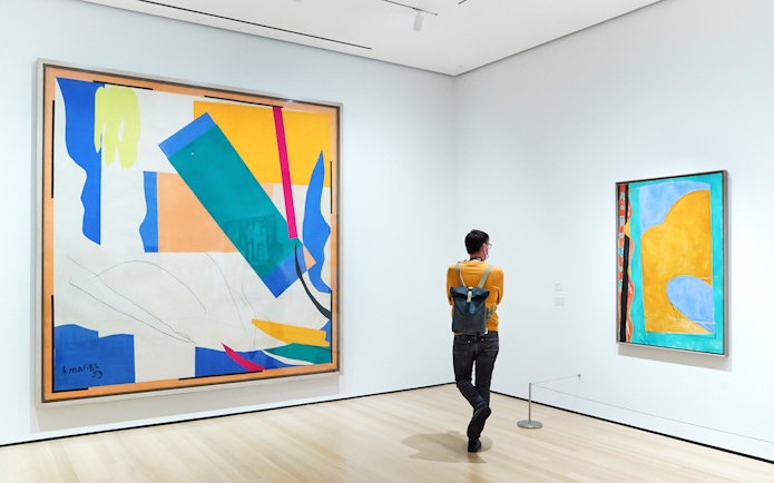 Visitor viewing abstract paintings at The Museum of Modern Art.