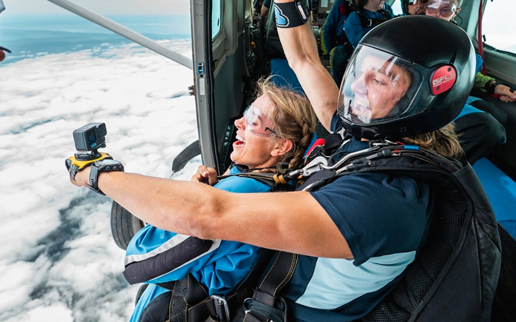 Tandem skydive over Sydney with instructor capturing the experience on camera.