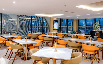 Coral Cosmo Lounge seating area with tables and chairs, Concourse C, Bangkok airport, Thailand.