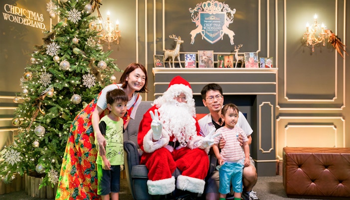 Family posing with Santa at Christmas Wonderland, near decorated tree, GBB Cloud Forest & SuperTree.