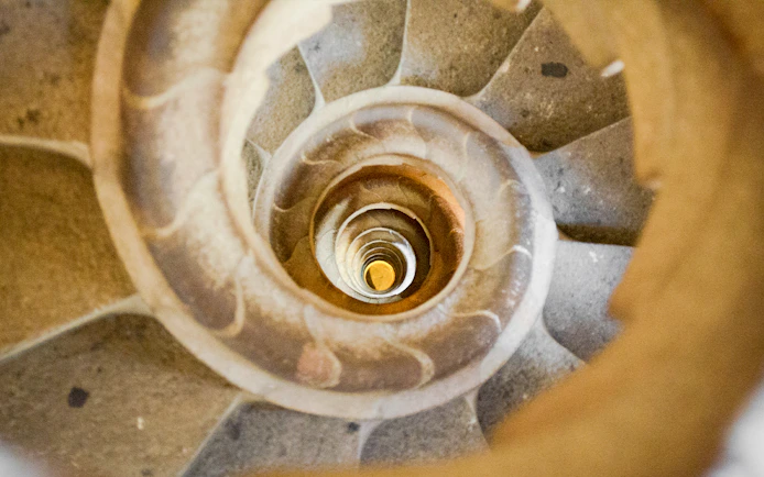 Sagrada Familia spiral staircase in Barcelona, Spain, viewed from above.