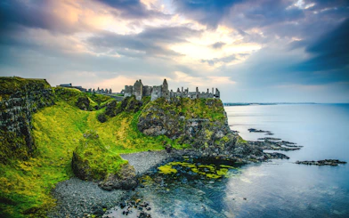 Dunluce Castle ruins on a cliff overlooking the sea in Northern Ireland.