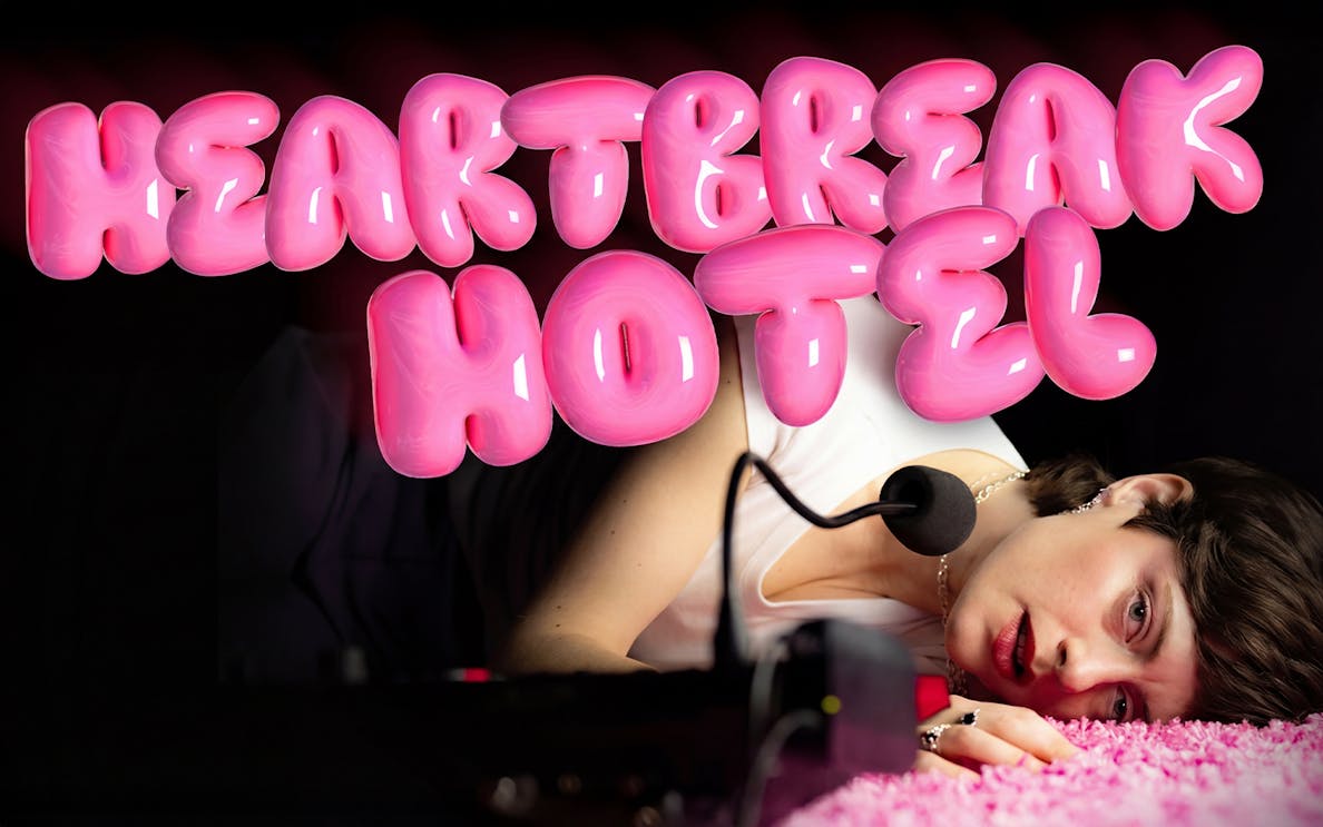 Person lying on pink carpet with microphone, "Heartbreak Hotel" in bold pink letters above.