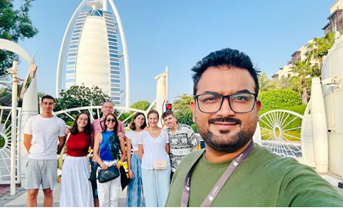 Group of tourists in front of Burj Al Arab during Dubai city tour.
