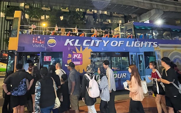 Kuala Lumpur night bus tour with people boarding the KL City of Lights double-decker.