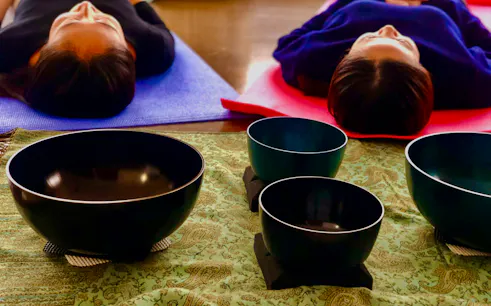 Participants lying on mats during a Japanese sound bath session in Kyoto.