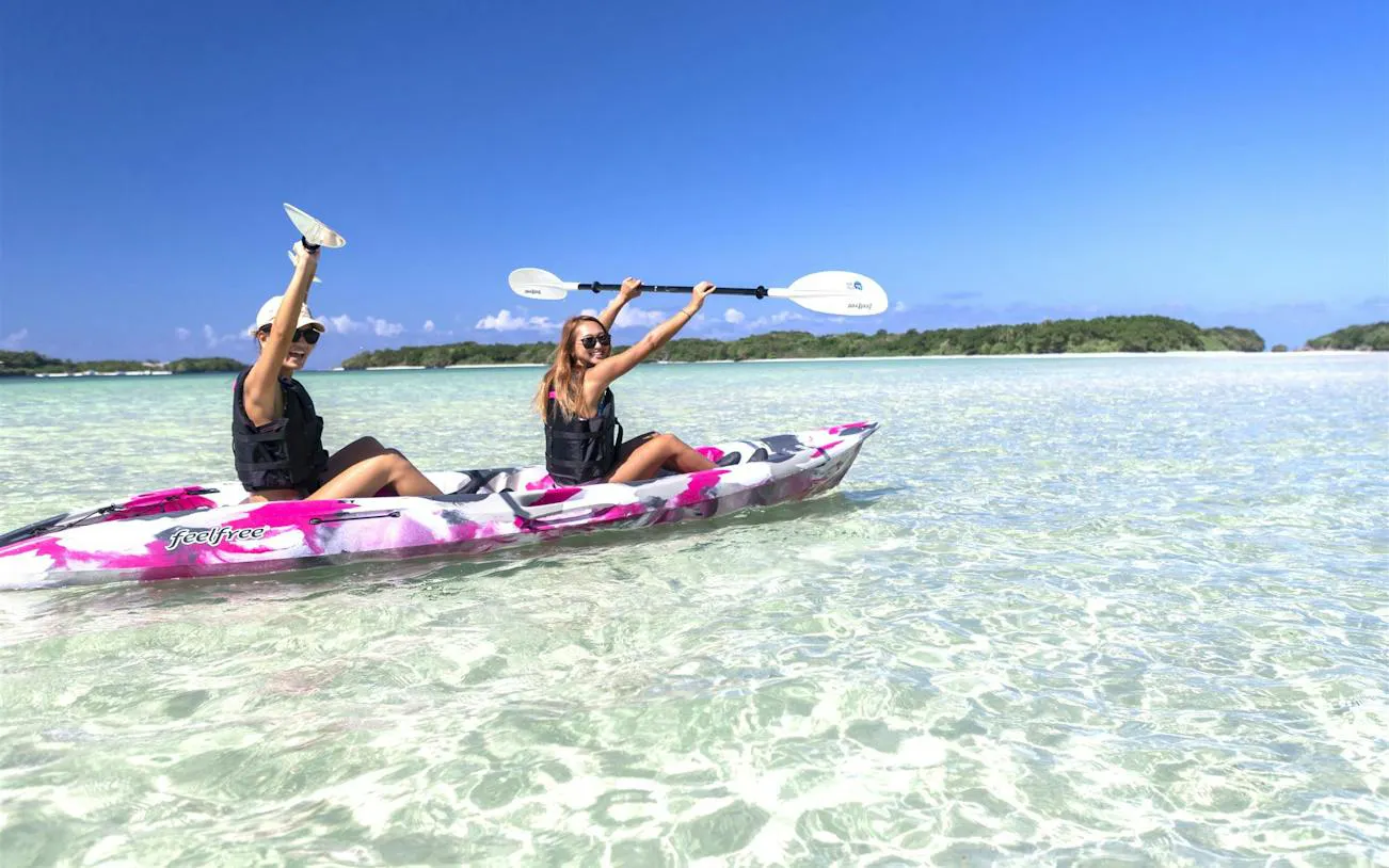 Kayakers paddling in clear waters at Kabira Bay, Ishigaki, Okinawa.