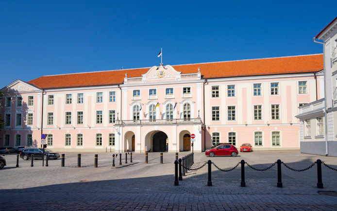 Toompea Castle facade in Tallinn, Estonia, with a clear blue sky.