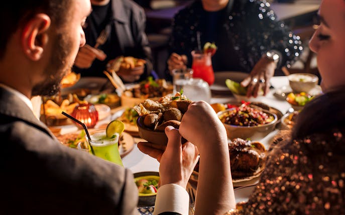 Dining experience at Al Hadheerah Restaurant, Bab Al Shams, with traditional dishes and drinks.