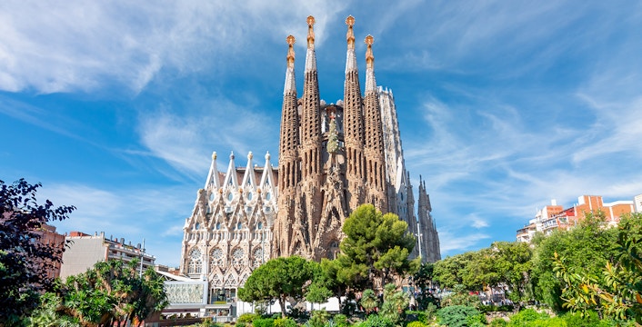 Sagrada Familia in Barcelona with reflection in pond.